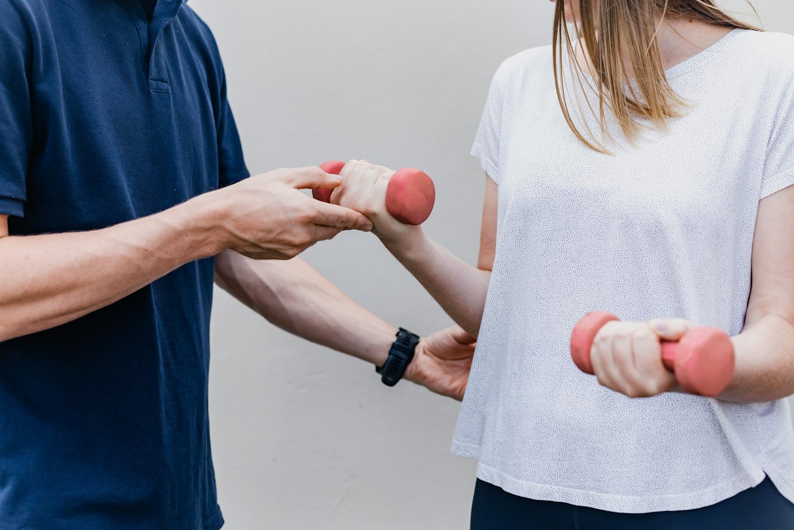 Allied health practitioner guiding a patient through a rehabilitation exercise