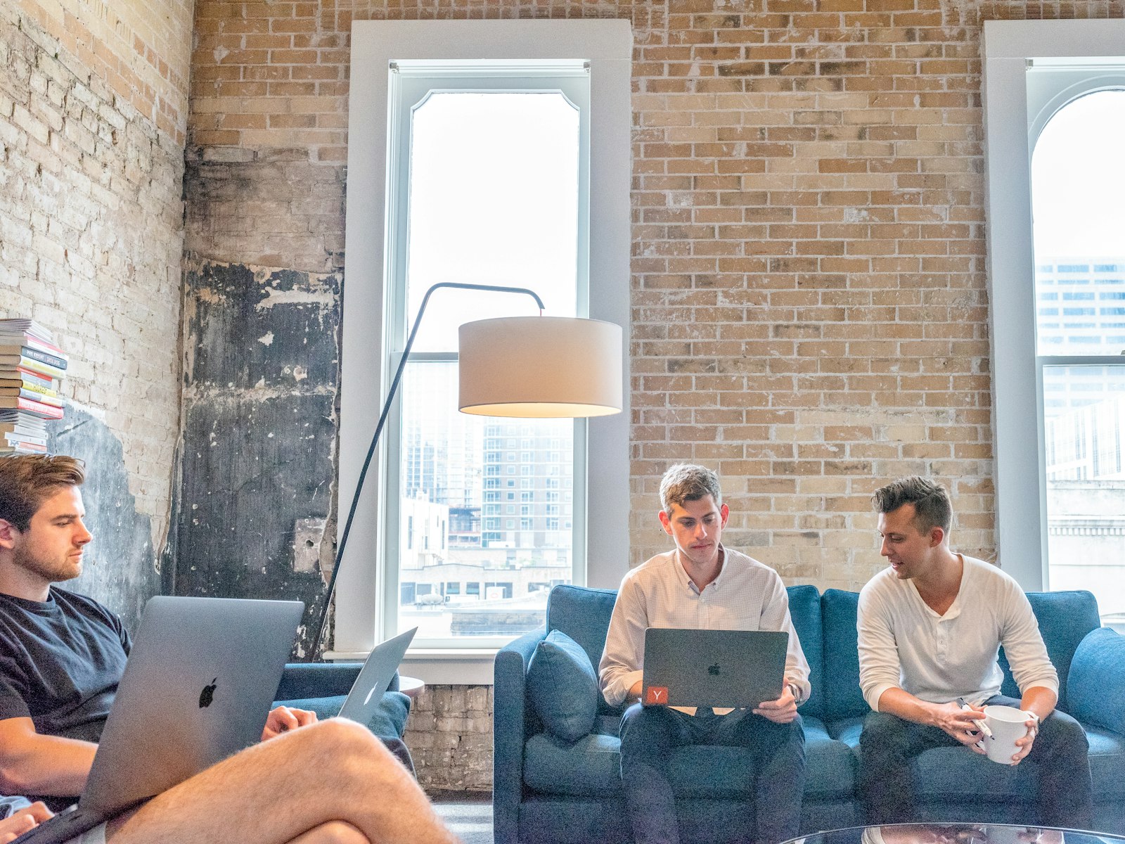 Recruitment team working together on laptops in a modern office